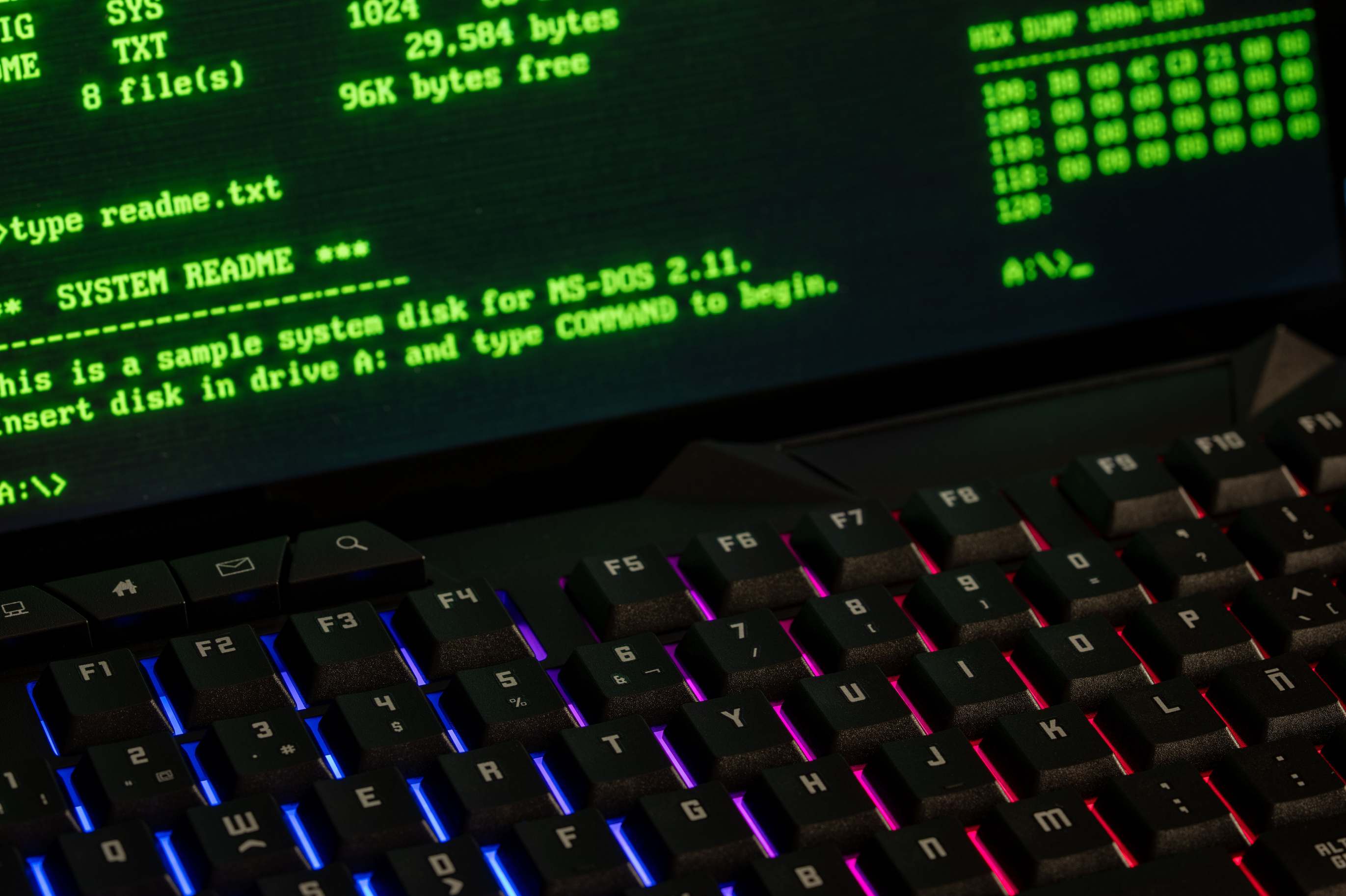 Computer monitor showing a terminal with code, close-up of a retro computer screen displaying MS-DOS commands