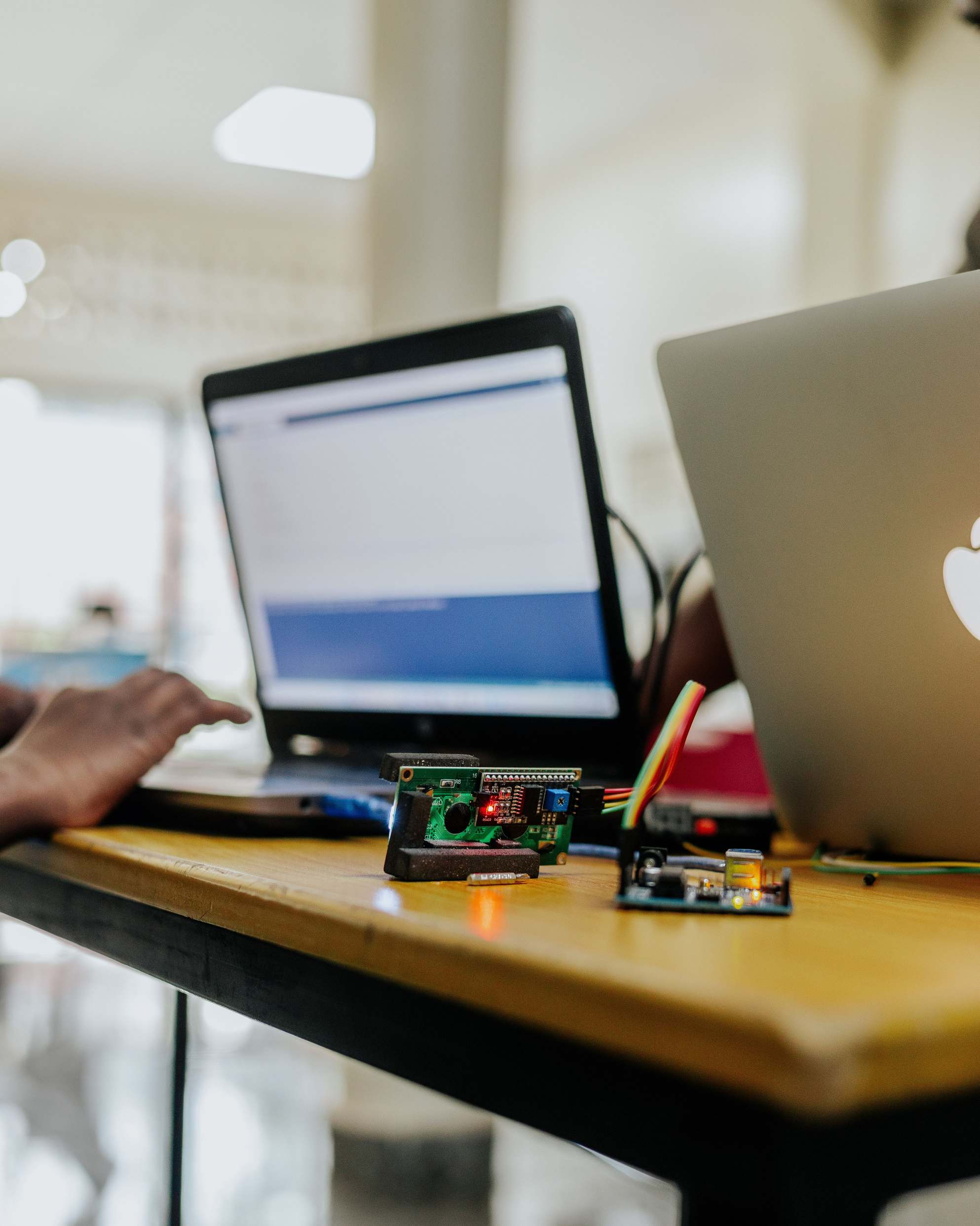 Hands typing on a laptop keyboard while coding